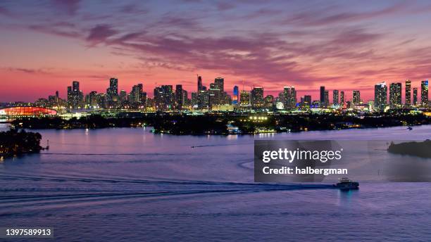 aerial view of biscayne bay and miami skyline - miami skyline night stock pictures, royalty-free photos & images