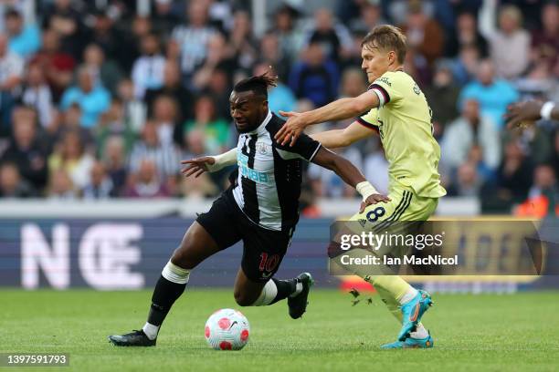 Allan Saint-Maximin of Newcastle United battles for possession with Martin Oedegaard of Arsenal during the Premier League match between Newcastle...