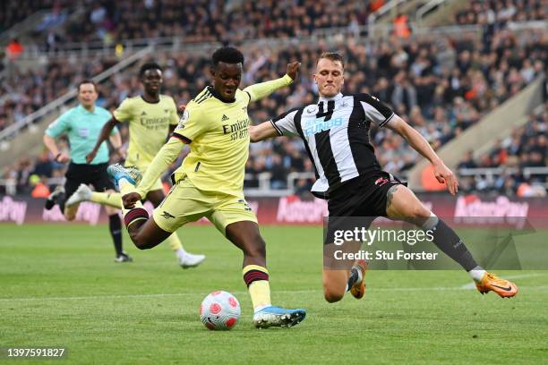 Eddie Nketiah of Arsenal shoots under pressure from Dan Burn of Newcastle United during the Premier League match between Newcastle United and Arsenal...