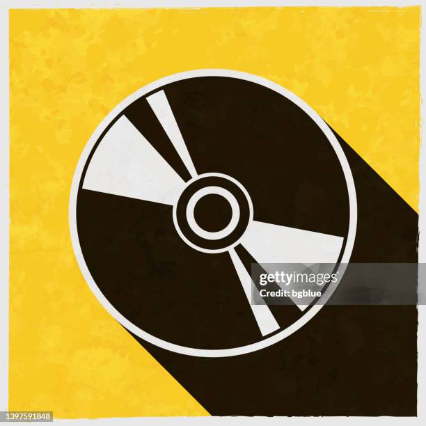 ilustrações de stock, clip art, desenhos animados e ícones de cd or dvd. icon with long shadow on textured yellow background - disco blu ray