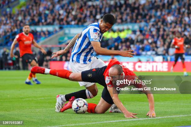 Danny Hylton of Luton Town is tackled by Levi Colwill of Huddersfield Town during the Sky Bet Championship Play-Off Semi Final 2nd Leg match between...