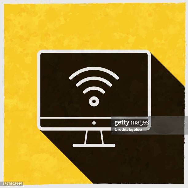 desktop computer with wifi. icon with long shadow on textured yellow background - tv screen texture stock illustrations