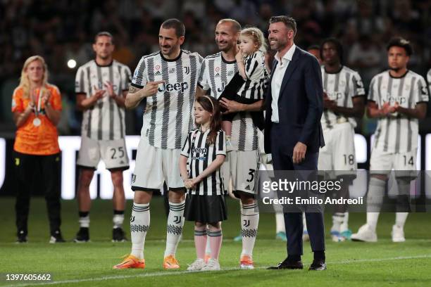 Giorgio Chiellini of Juventus poses for a photo with his daughters Nina and Olivia, teammate Leonardo Bonucci of Juventus and former Juventus player...
