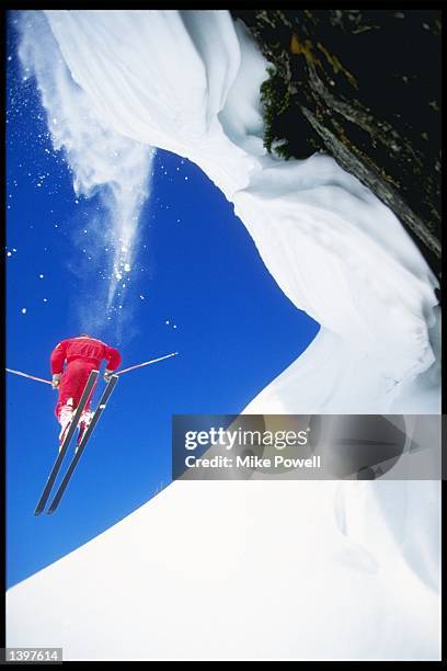 Skier jumps down a slope while heli-skiing at Selkirk Tangiers in British Columbia, Canada. Mandatory Credit: Mike Powell /Allsport