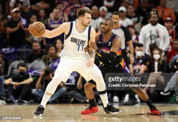 Luka Doncic of the Dallas Mavericks handles the ball against Chris Paul of the Phoenix Suns in Game Seven of the 2022 NBA Playoffs Western Conference...