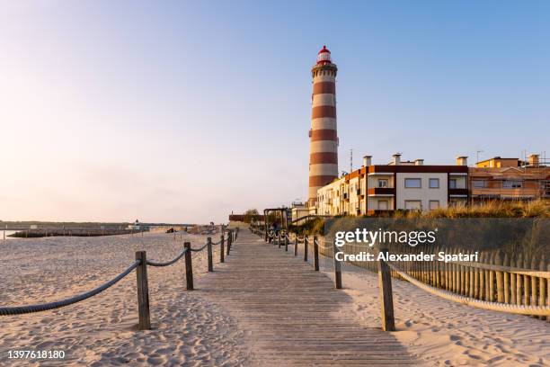 lighthouse and beach at praia da barra - aveiro stockfoto's en -beelden