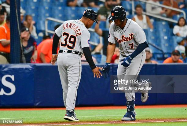 Jonathan Schoop of the Detroit Tigers celebrates with Ramon Santiago after hitting a two-run home run in the fourth inning against the Tampa Bay Rays...
