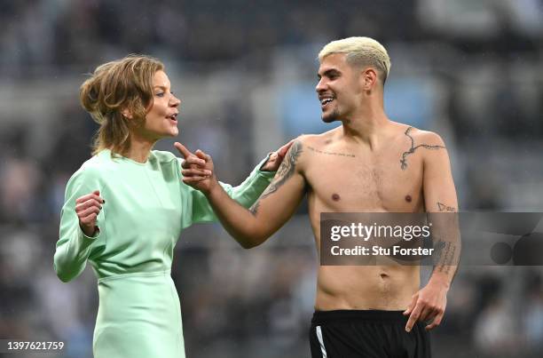 Newcastle player Bruno Guimaraes shares a joke with co-owner Amanda Staveley on the pitch after the Premier League match between Newcastle United and...