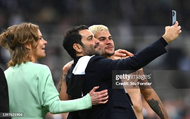 Newcastle player Bruno Guimaraes has a selfie picture with co-owners Amanda Staveley and Mehrdad Ghodoussi on the pitch after the Premier League...