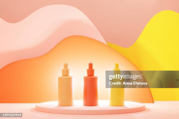 vibrant colorful serum bottles on bright background. red, orange and yellow colors. - land feature stock photos et images de collection