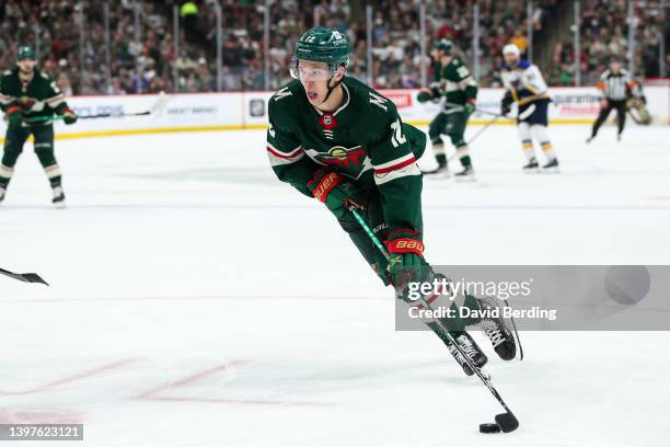Matt Boldy of the Minnesota Wild skates with the puck against the St. Louis Blues in the second period in Game Five of the First Round of the 2022...