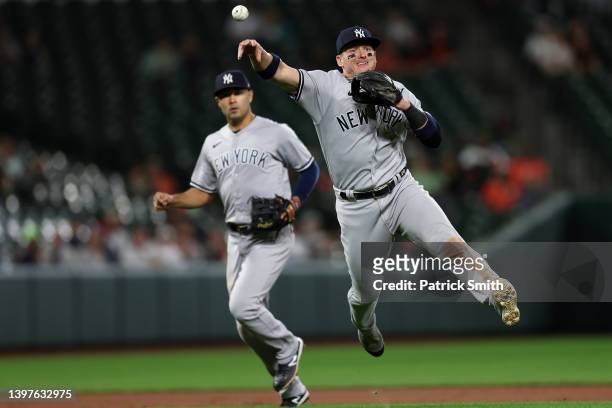 Josh Donaldson of the New York Yankees makes a play on a hit by Rylan Bannon of the Baltimore Orioles during the eighth inning Oriole Park at Camden...