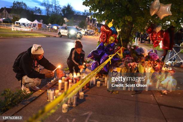 Mourners light candles at a makeshift memorial outside of Tops market on May 16, 2022 in Buffalo, New York. A gunman opened fire at the store...