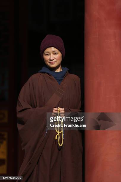 a chinese nun in a temple - buddist nun stock pictures, royalty-free photos & images