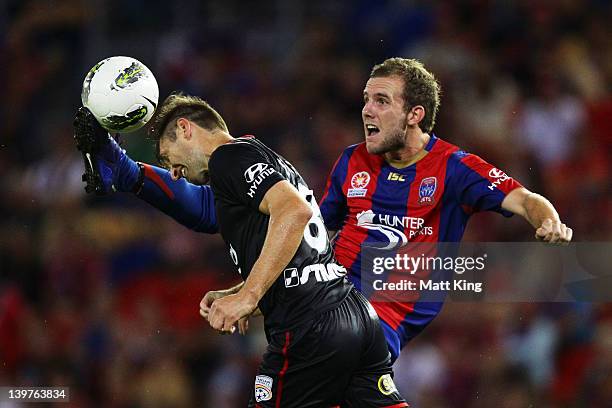 Jeremy Brockie of the Jets clashes with Yevgen Levchenko of United during the round 21 A-League match between the Newcastle Jets and Adelaide United...