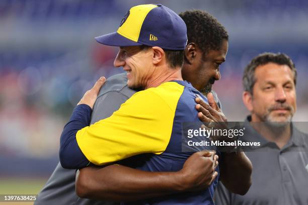 Former Florida Marlin and current manager Craig Counsell of the Milwaukee Brewers hugs Antonio Alfonseca as he is introduced during a ceremony to...