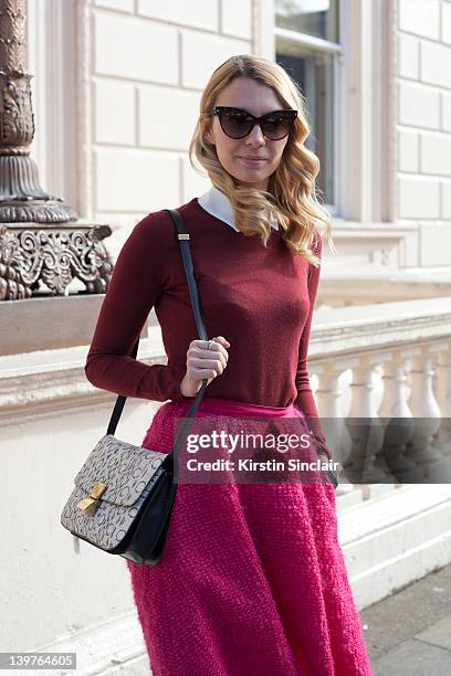 Roberta Benteler founder of Avenue 32.com wearing Miu Miu jumper, Nina Ricci skirt, Christian Dior sunglasses and a Celine bag street style at London...