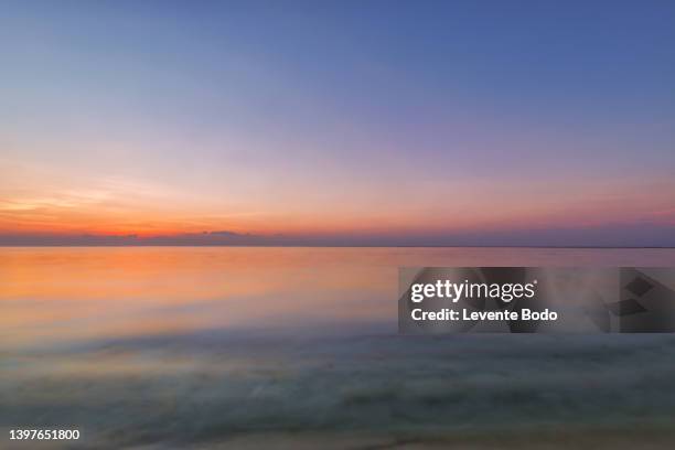 closeup sea sand beach. panoramic beach landscape. inspire tropical beach seascape horizon. orange and golden sunset sky calmness tranquil relaxing sunlight summer mood. vacation travel holiday banner - territórios ultramarinos franceses imagens e fotografias de stock