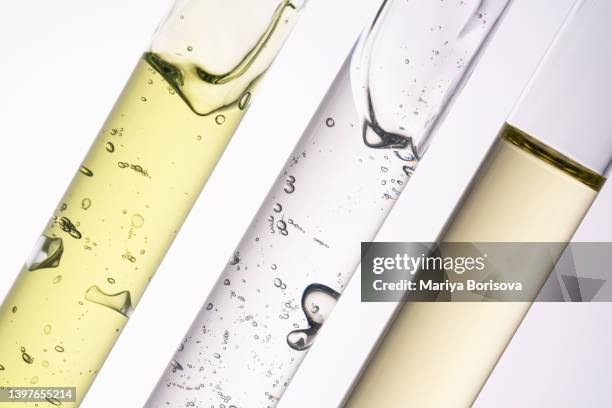 three test tubes with green gel, transparent cosmetic gel and oil. - beauty treatment ストックフォトと画像