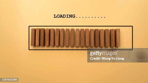 wooden blocks with the word loading in loading bar progress concept photo - progress bar stock pictures, royalty-free photos & images