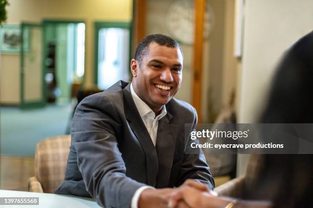 black american male loan officer and black female non-profit owner discussing finances us diverse social services - banker stock pictures, royalty-free photos & images