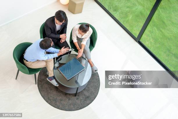 japanese man real estate agent offer home ownership and life insurance to a couple. - agency stock pictures, royalty-free photos & images