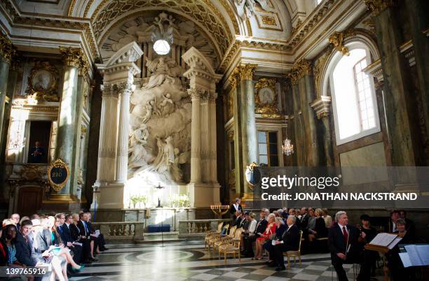 Guests wait for the Royal family's arrival for a Te Deum traditional religious service at the Royal Palace's church on February 24, 2012 in...