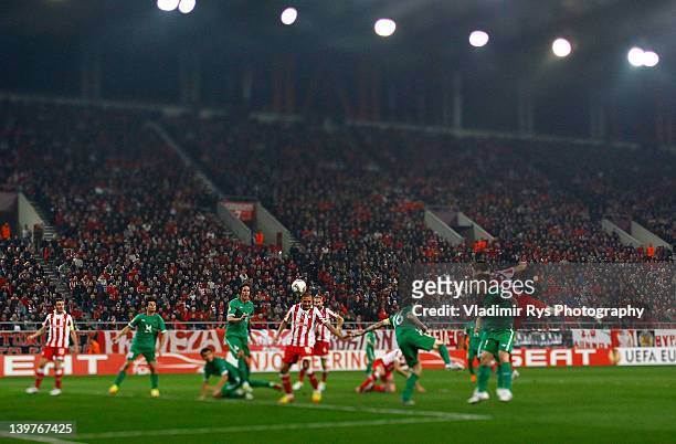 Rafik Djebbour of Olympiacos scores his team's first goal during the UEFA Europa League Round of 32 second leg match between Olympiacos FC and FC...