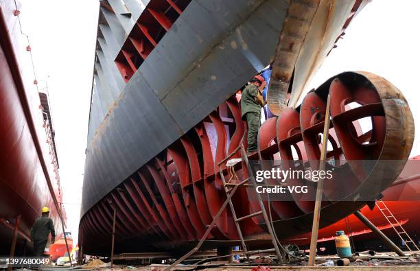 Shipbuilder welds the hull of a ship at Dongyuan Shipyard on May 17, 2022 in Lianyungang, Jiangsu Province of China.