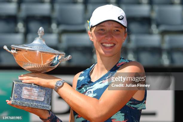 Iga Swiatek of Poland celebrates with the Internazionali BNL D'Italia Women's Singles trophy after their victory against Ons Jabeur of Tunisia during...