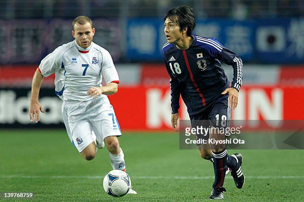 Ryoichi Maeda of Japan and Steinthor Freyr Thorsteinsson of Iceland contest the ball during the Kirin Challenge Cup international friendly match...