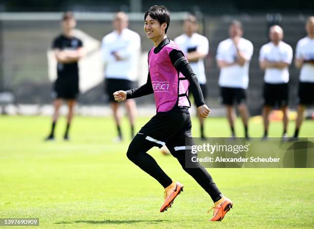 Daichi Kamada of Eintracht Frankfurt smiles during a Eintracht Frankfurt Training Session at Deutsche Bank Park on May 17, 2022 in Frankfurt am Main,...