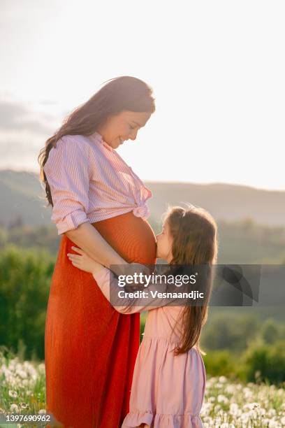 happy family at nature - belly kissing stock pictures, royalty-free photos & images