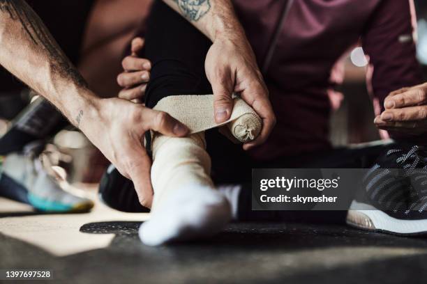 bandaging an injured ankle! - ankle stock pictures, royalty-free photos & images