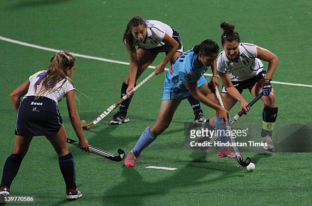 Indian player Rani Rampal is surrounded by Italian players during the FIH London Olympics hockey qualifying match between India and Italy at National...