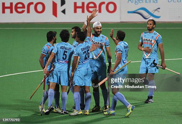 Indian hockey player Sandeep Singh celebrates with team members after victory during the FIH London Olympics men's hockey qualifying match between...