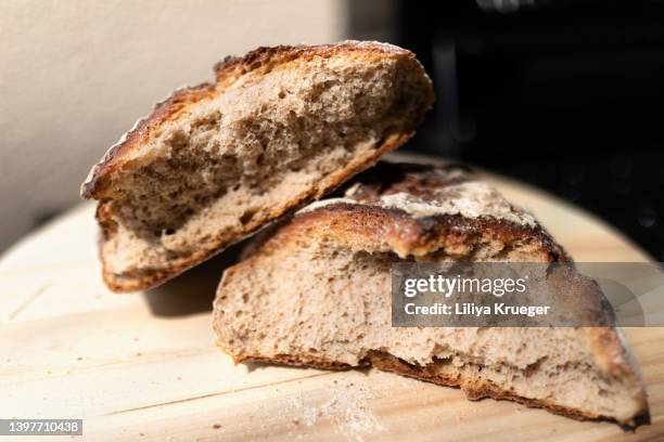 fresh broken bread. - loaf of bread bildbanksfoton och bilder