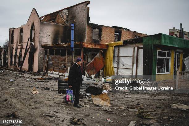 Local resident walks passed destroyed houses close to the central train station that was used as a Russian base on March 28, 2022 in Trostianets,...
