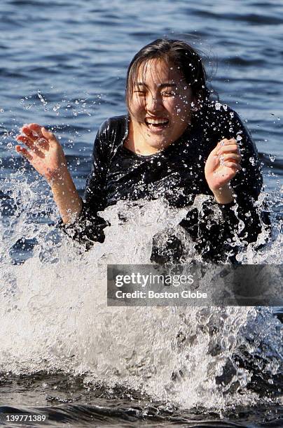 Wellesley College senior Susan Wang takes a dip in the lake after winning the school's 114th annual hoop-rolling contest, Saturday, Apr. 25, 2009....