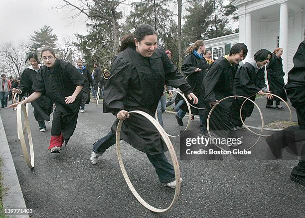 Senior Wellesley College students roll hoops as part of the odd, archaic ritual that's been a rite of spring for 112 years. The winner, not pictured,...