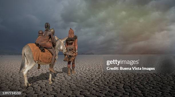 himba woman with sons on a donkey - opuwo tribe foto e immagini stock