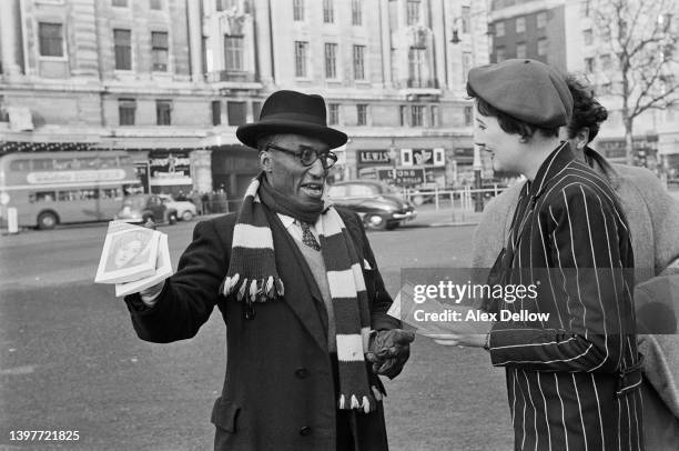 South African nursery nurse Patricia Farrier talks to a man after moving to England because she didn't agree with the system of apartheid, London,...