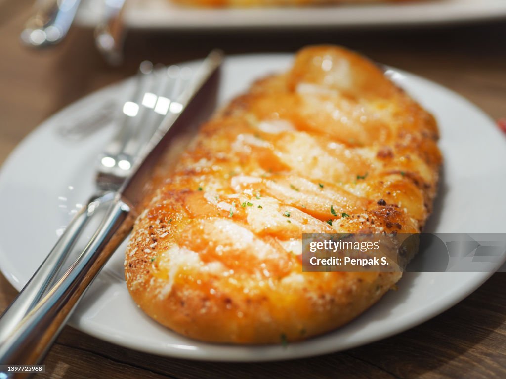 Sausage and Cheese Toast, bread food background on white plate, spoon and fork
