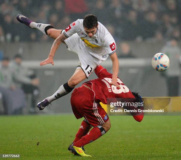 Roman Neustaedter of Moenchengladbach challenges Tolgay Arslan of Hamburg during the Bundesliga match between Borussia Moenchengladbach and Hamburger...