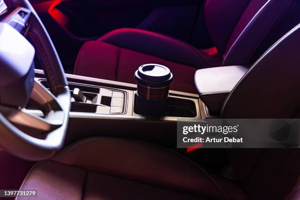 reusable coffee cup inside car with cup holders. - car coaster stock pictures, royalty-free photos & images