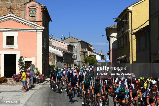 General view of the peloton passing through Montefano Village while fans cheer during the 105th Giro d'Italia 2022, Stage 10 a 196km stage from...
