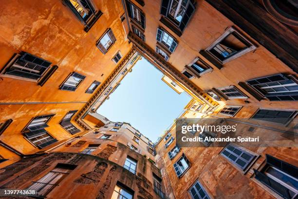 low wide angle view of residential apartments house inner court yard in rome, italy - condominio foto e immagini stock