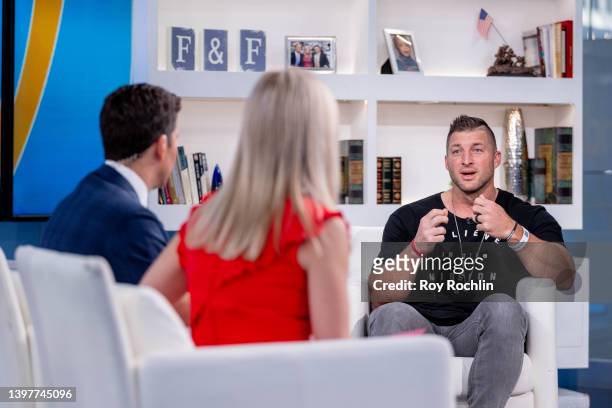 Former NFL player Tim Tebow visits "Fox & Friends" to promote his new children's book "Mission Possible" at Fox News Channel Studios on May 17, 2022...