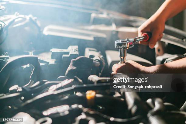 shine a light to inspect the car under the car's chassis at the old garage. - diy disaster stock pictures, royalty-free photos & images