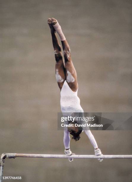 Dominique Dawes of the United States performs on the Uneven Bars on July 28, 1992 during the Team All-Around event of the Women's Gymnastics...